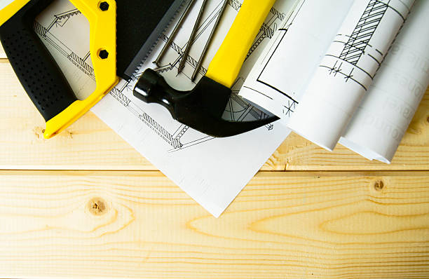 istock Drawings for building and working tools on wooden background 469549212
