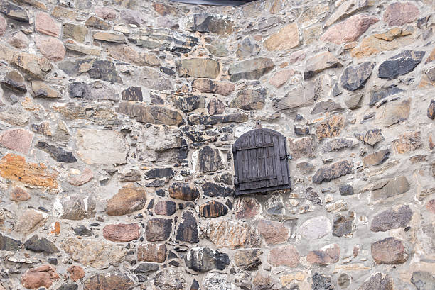 istock Old field stone wall background with wooden door 469549471