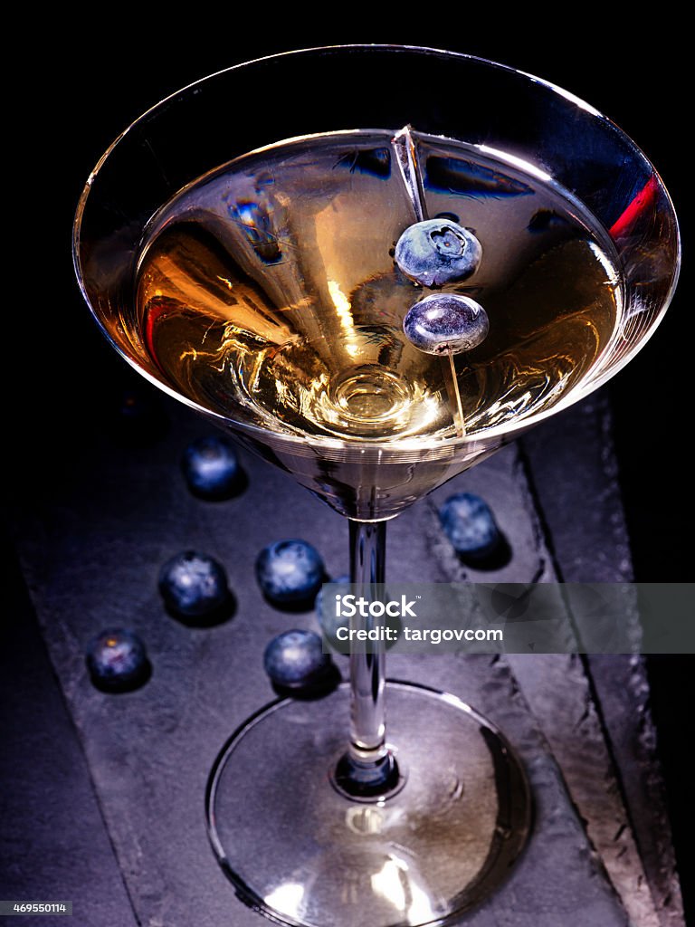 Blueberry cocktail  on black background 21 Dark berry gold drink on black background. Cocktail card 21 2015 Stock Photo