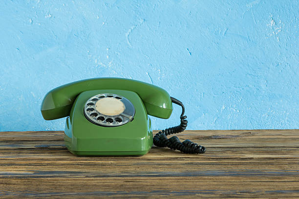 istock Vintage phone on a wooden table 469550384
