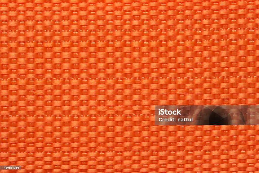 Closeup of orange color Polyester bag textile Closeup of orange color Polyester bag textile handler background 2015 Stock Photo