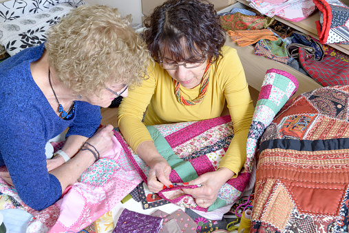 two women working on their patchwork in the workshop