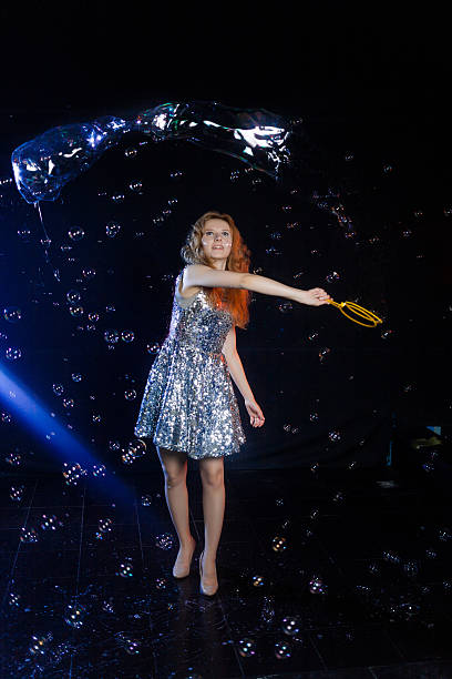 istock Girl is showing soap bubbles show 469551592