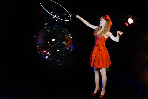 istock Girl is showing soap bubbles show 469551618