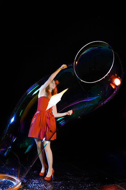 istock Girl is showing soap bubbles show 469551624