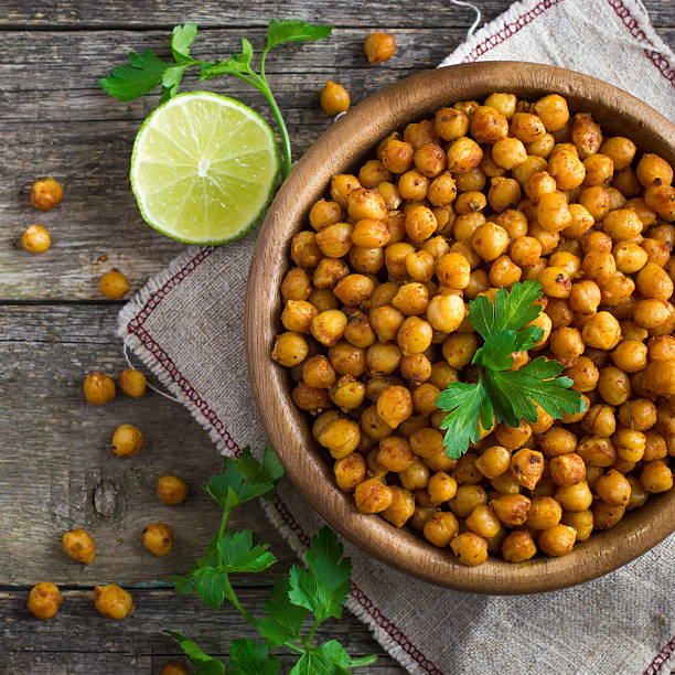 Roasted  spicy chickpeas on rustic background stock photo