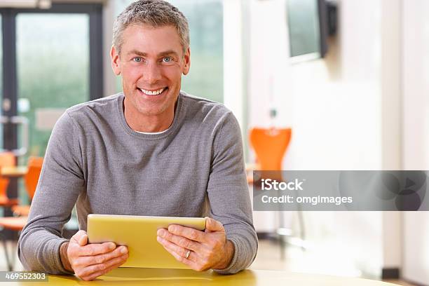Mature Student Studying In Classroom With Digital Tablet Stock Photo - Download Image Now