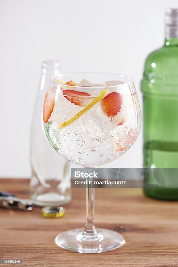 Strawberry gintonic on balon glass Strawberry gintonic on balon glass with a twist of lemon Tonic Water Stock Photo