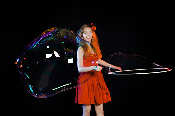 istock Girl is showing soap bubbles show 469554078