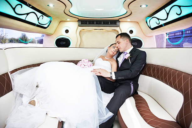 istock Bride and groom in limousine 469555419