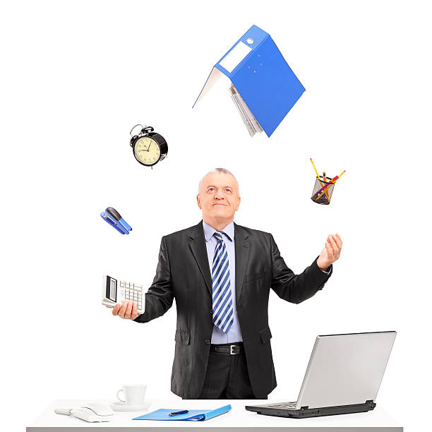 istock Mature businessman juggling in his office 469555749