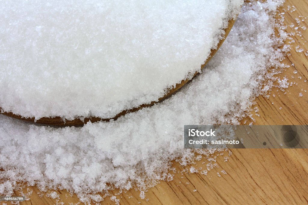 Epsom salts spilling into the floor from a bowl Closeup photo of fine Magnesium sulfate (Epsom salts) Alternative Therapy Stock Photo