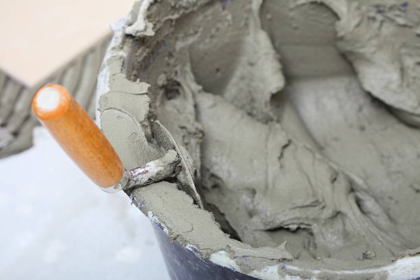 istock dirty trowel and bucket on building site 469557327