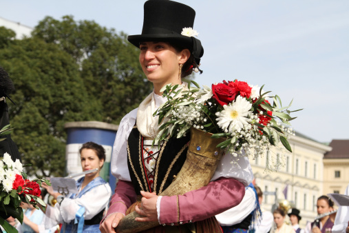 Munich, Germany  - September 22, 2013: on the float of grand oktoberfest parade of regional costums a woman of the group \