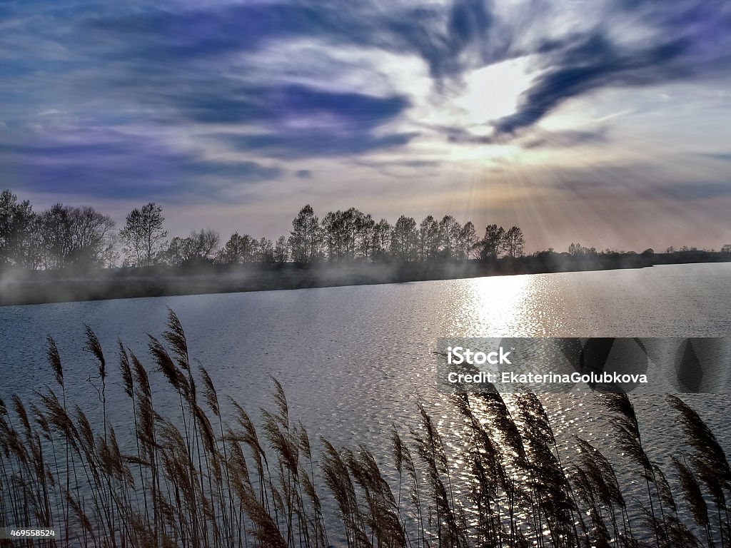 Mysterious landscape of the lakeside and fabulous sky There is mysterious landscape of the lakeside. Heavy fog, sunrays and fabulous sky make the picture unusual and expressive. 2015 Stock Photo