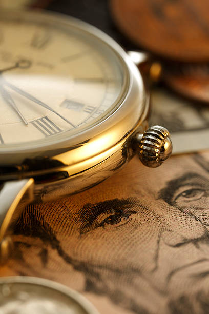 istock Time and Money. Clock in US dollars - Stock Image 469558700