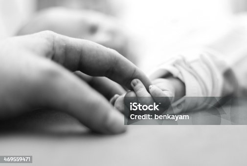 istock Baby is holding father's finger for the first time 469559471