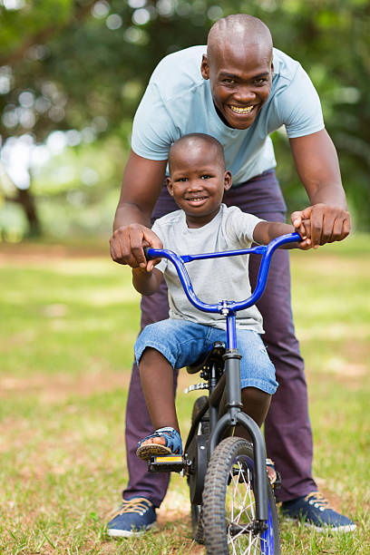 istock african father helping son ride a bike 469561080