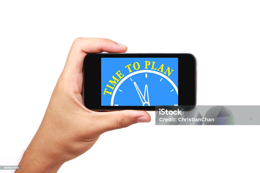 Time to plan Hand is holding the smartphone of time to plan concept isolated on white background. 2015 Stock Photo