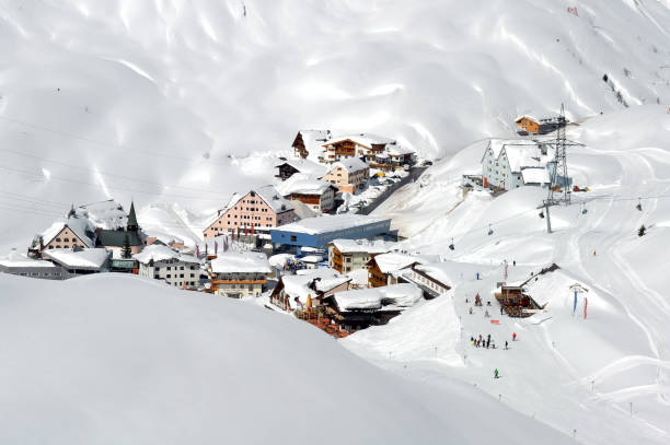 Ski lift - St Christoph - Skiing St. Christoph am Arlberg, Austria - March 28, 2009, A view down of the idyllic litlle village St. Christoph in the skiresort of St. Anton, Austria. Skiers skiing down the piste in the snow covered sunny winterlandscape. winter village austria tirol stock pictures, royalty-free photos & images