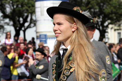 Munich, Germany  - September 22, 2013: blonde lady with hat and grey bavarian jacket in the float of the grand parade of traditional costumes in ludwigstraße, munich