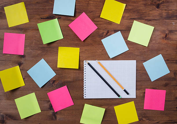 istock chaotic colored stickers notebook and two pencils 469565086
