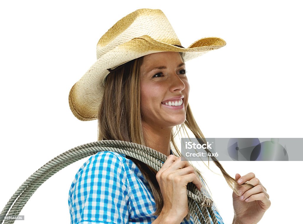 Cheerful cowgirl holding lasso and looking away Cheerful cowgirl holding lasso and looking awayhttp://www.twodozendesign.info/i/1.png 20-29 Years Stock Photo