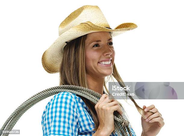 Cheerful Cowgirl Holding Lasso And Looking Away Stock Photo - Download Image Now - 20-29 Years, 2015, 25-29 Years