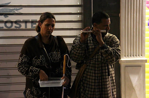 Istanbul, Turkey - October 31, 2012:  Street musician is plying flute instrument. The photograph was taken in istanbul, Musicians is blind and they are earning money.
