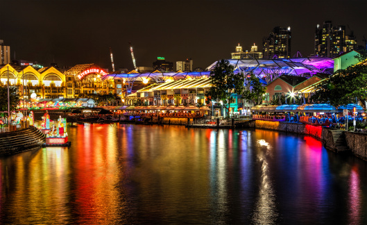 Singapore, Singapore - September 24, 2012: Bars and restaurants draw a large crowd to Riverside Point on the Singapore River at Clarke Quay. The popular meeting place for locals and tourists alike are surrounded by a kaleidoscope of colorful neon lights and brightly lit lanterns in celebration of the Lantern Festival.