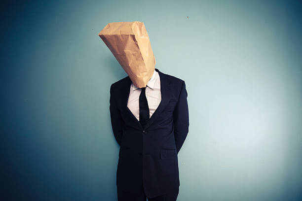 sad and ashamed businessman with bag over head sad and ashamed businessman with bag over head signs and symbols stock pictures, royalty-free photos & images