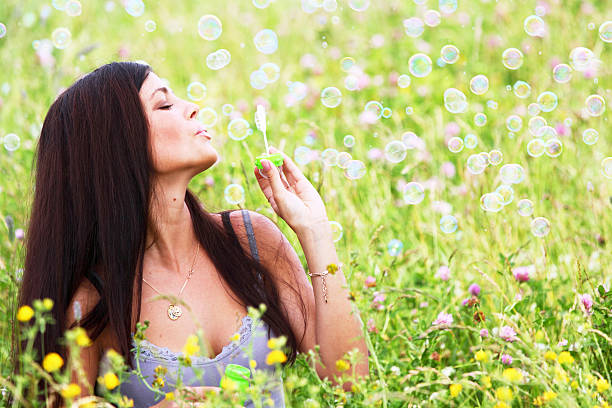 istock Woman blows soap bubbles 469567522