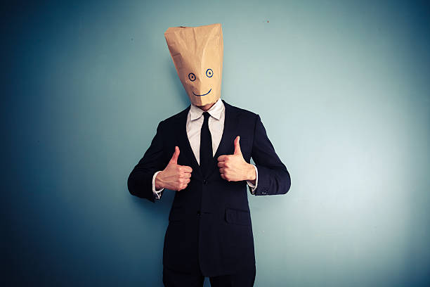 istock Businessman with bag over head giving two thumbs up 469567821