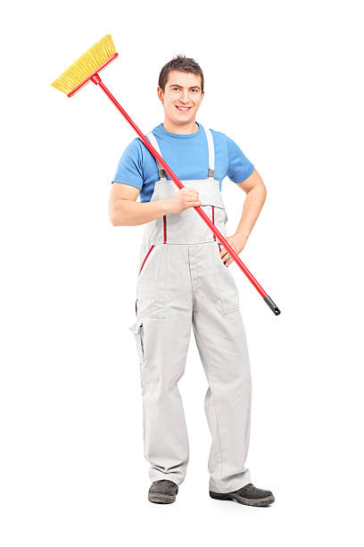 istock Confident cleaner in a uniform with broom 469567843