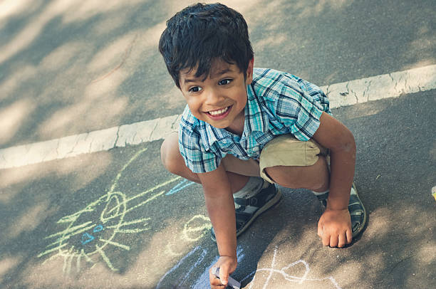 istock Happy little boy chalking 469569212