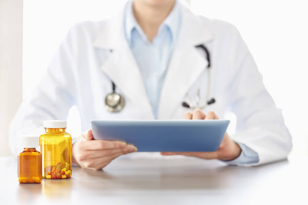 istock Midsection image of a female doctor using digital tablet 469571706