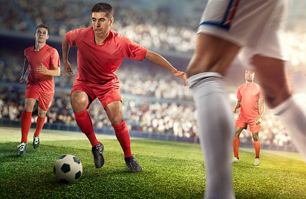 istock Soccer player kicking ball in stadium 469572368