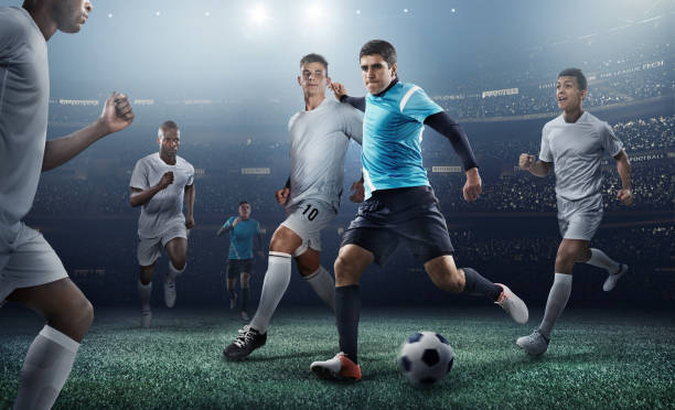 istock Soccer player kicking ball in stadium 469572384