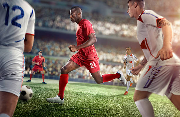 istock Soccer player kicking ball in stadium 469572416