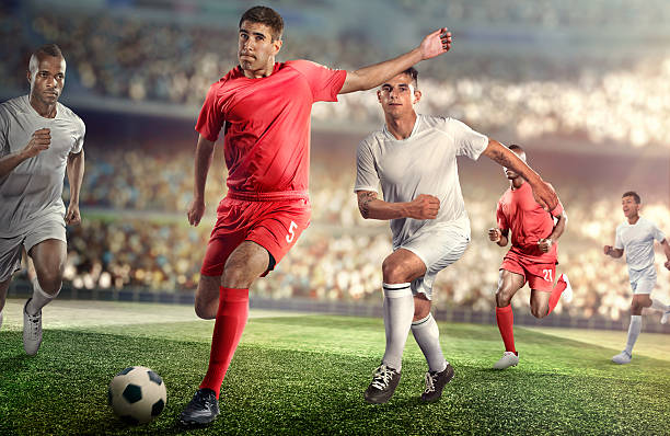 istock Soccer player kicking ball in stadium 469572452