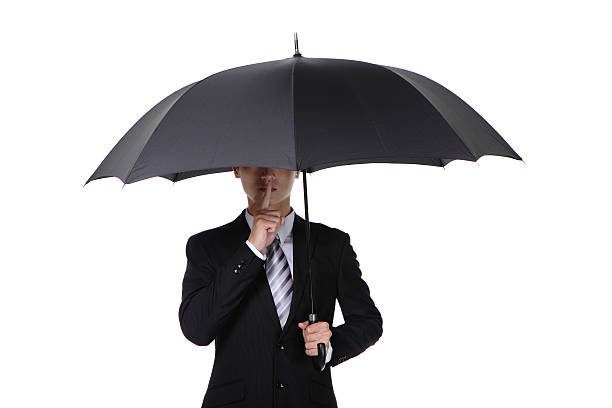 istock Business man asking for silence with umbrella 469572663