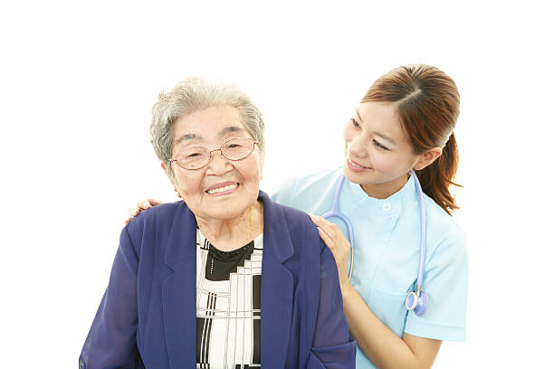istock Smiling nurse with old woman 469575133