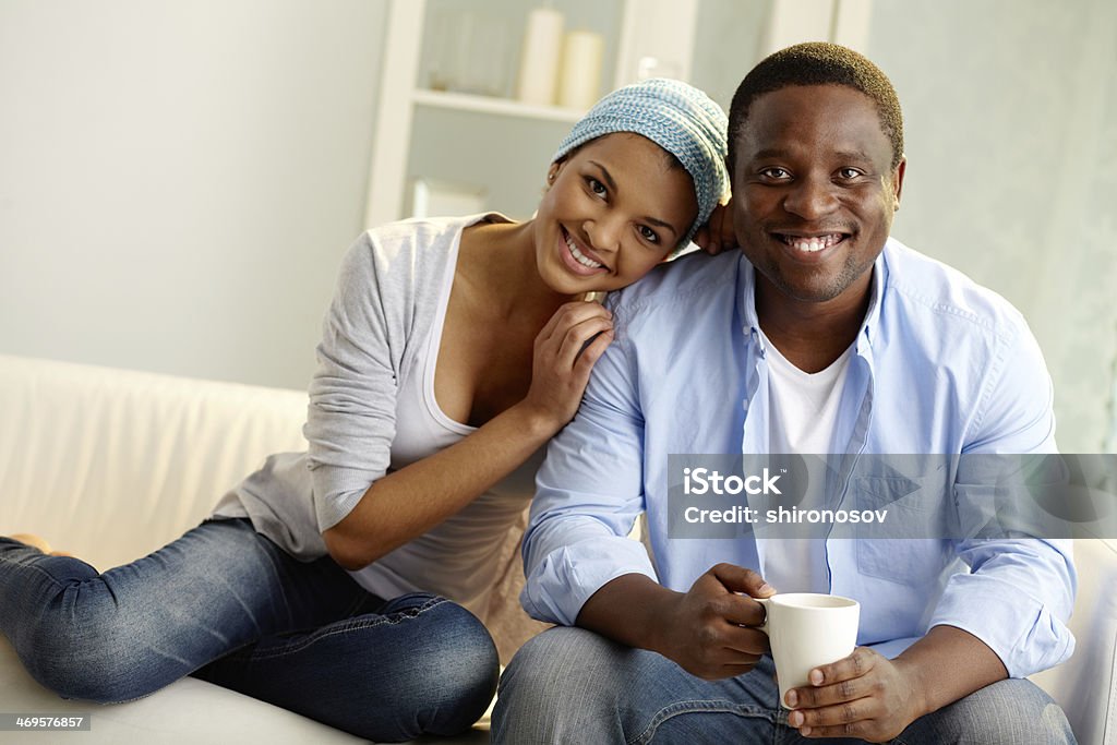 Togetherness Image of young African couple looking at camera with smiles Adult Stock Photo