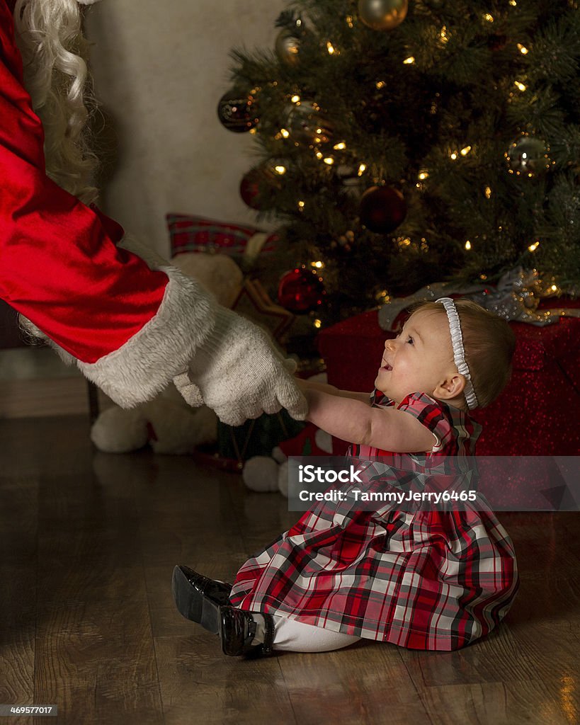 Playing With Santa Baby see's and touches santa for the first time Celebration Stock Photo