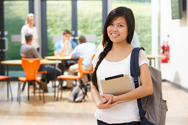 istock Female student with backpack in a cafeteria background 469577039
