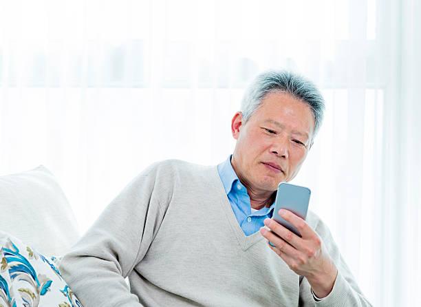 istock senior businessman holding a smart phone 469577186