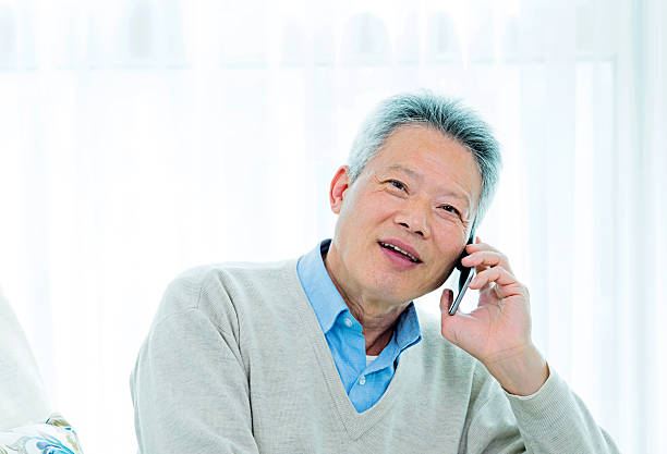 istock senior asian man talking on phone 469577828