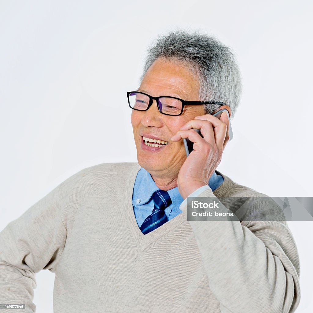 senior businessman talking on phone Portrait of confident senior businessman talking on phone isolated on white background. 2015 Stock Photo