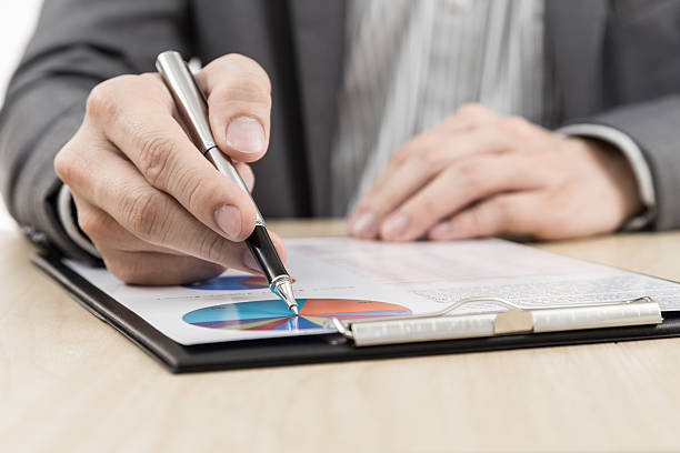 istock Businessman's hand showing financial report 469582305