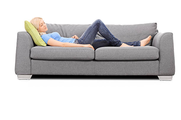 istock Young blond woman sleeping on a gray sofa 469584018